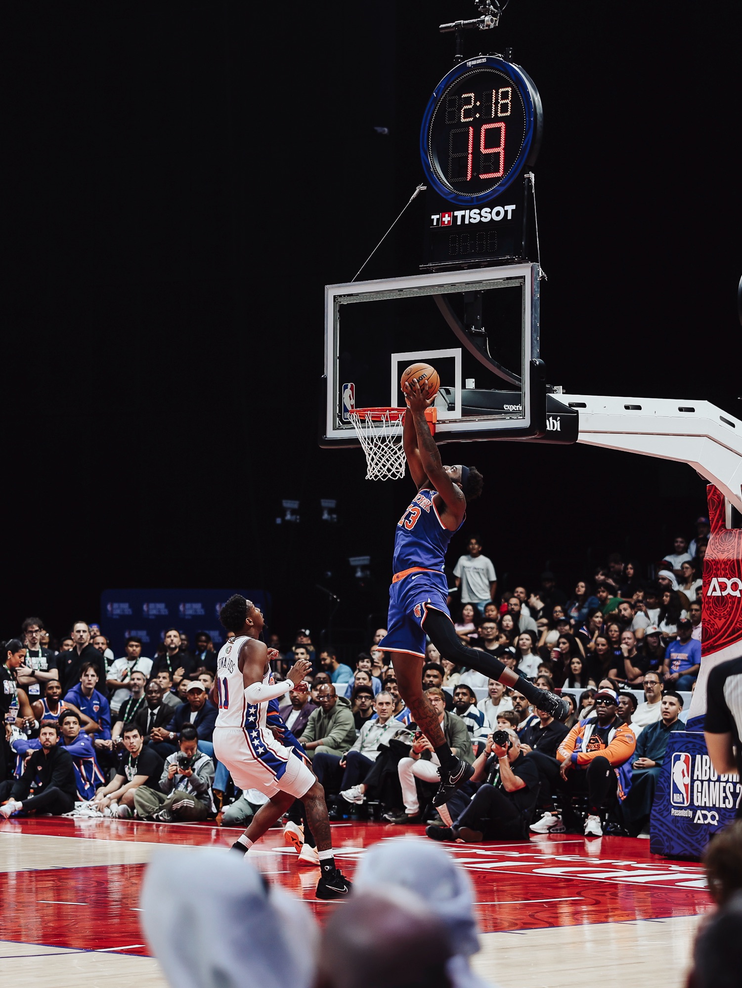 New York No. 23 rising for a layup over a Philadelphia defender in a packed arena