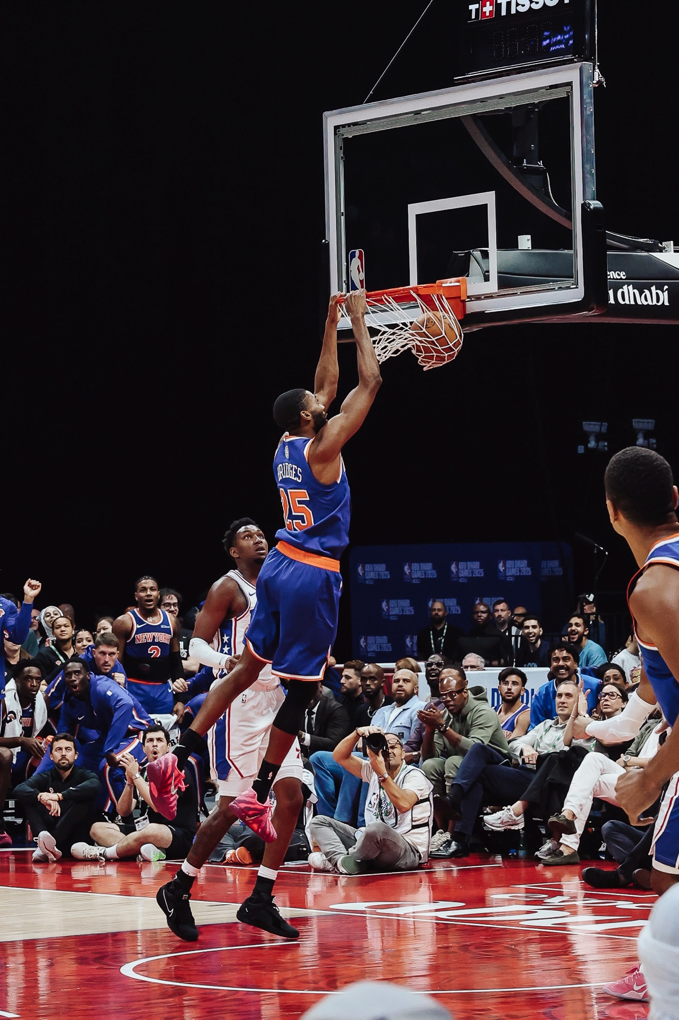 New York No. 25 hanging on the rim after a two-handed dunk