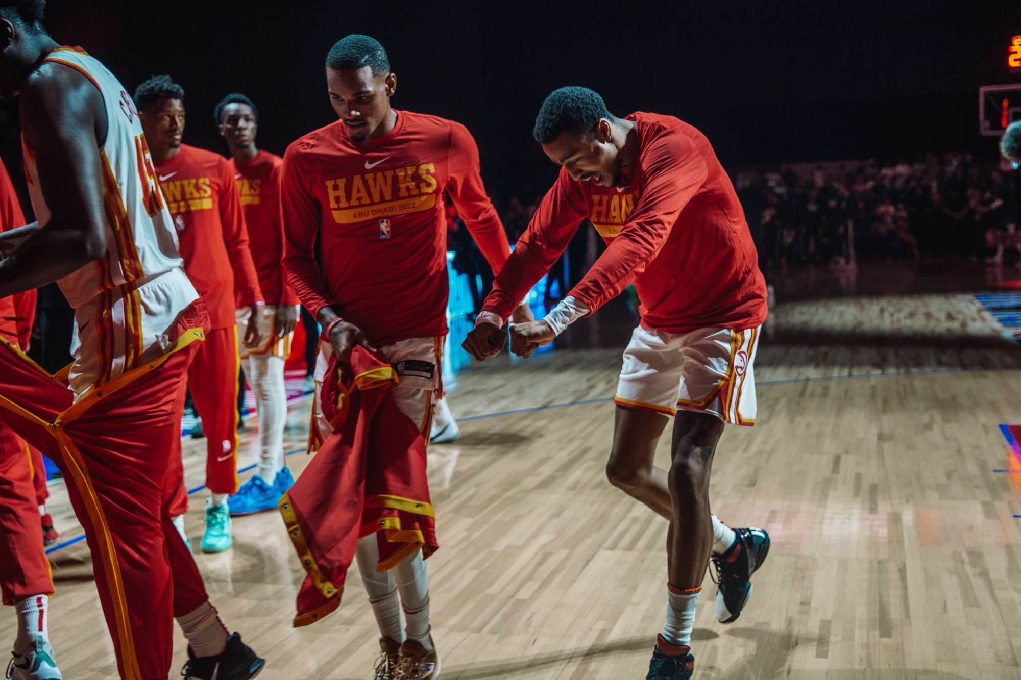 Atlanta Hawks players in red warm-up shirts celebrating during pre-game introductions