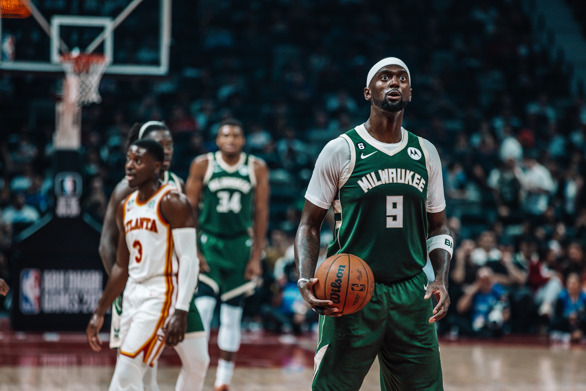 Player in a green Milwaukee No. 9 jersey holding the ball at the free-throw line