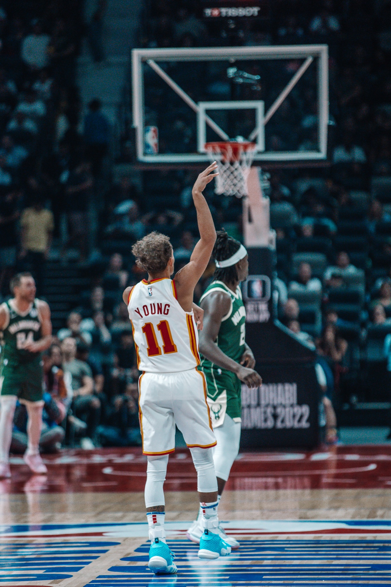Player in a white Atlanta No. 11 jersey following through on a free throw