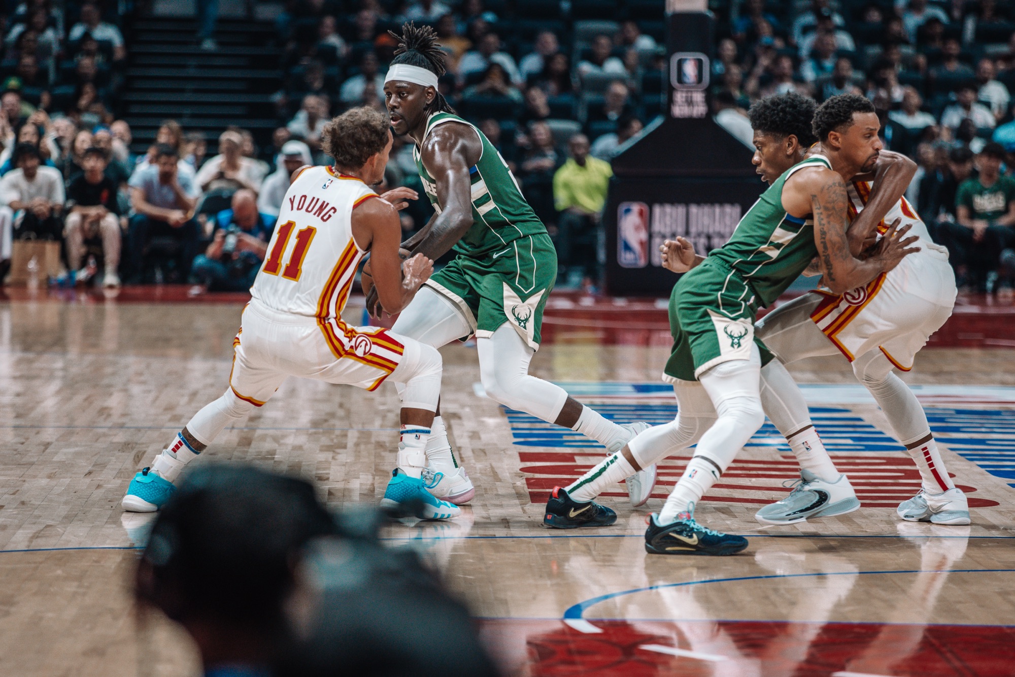 Atlanta No. 11 guarding a Milwaukee ball handler as players jostle for position