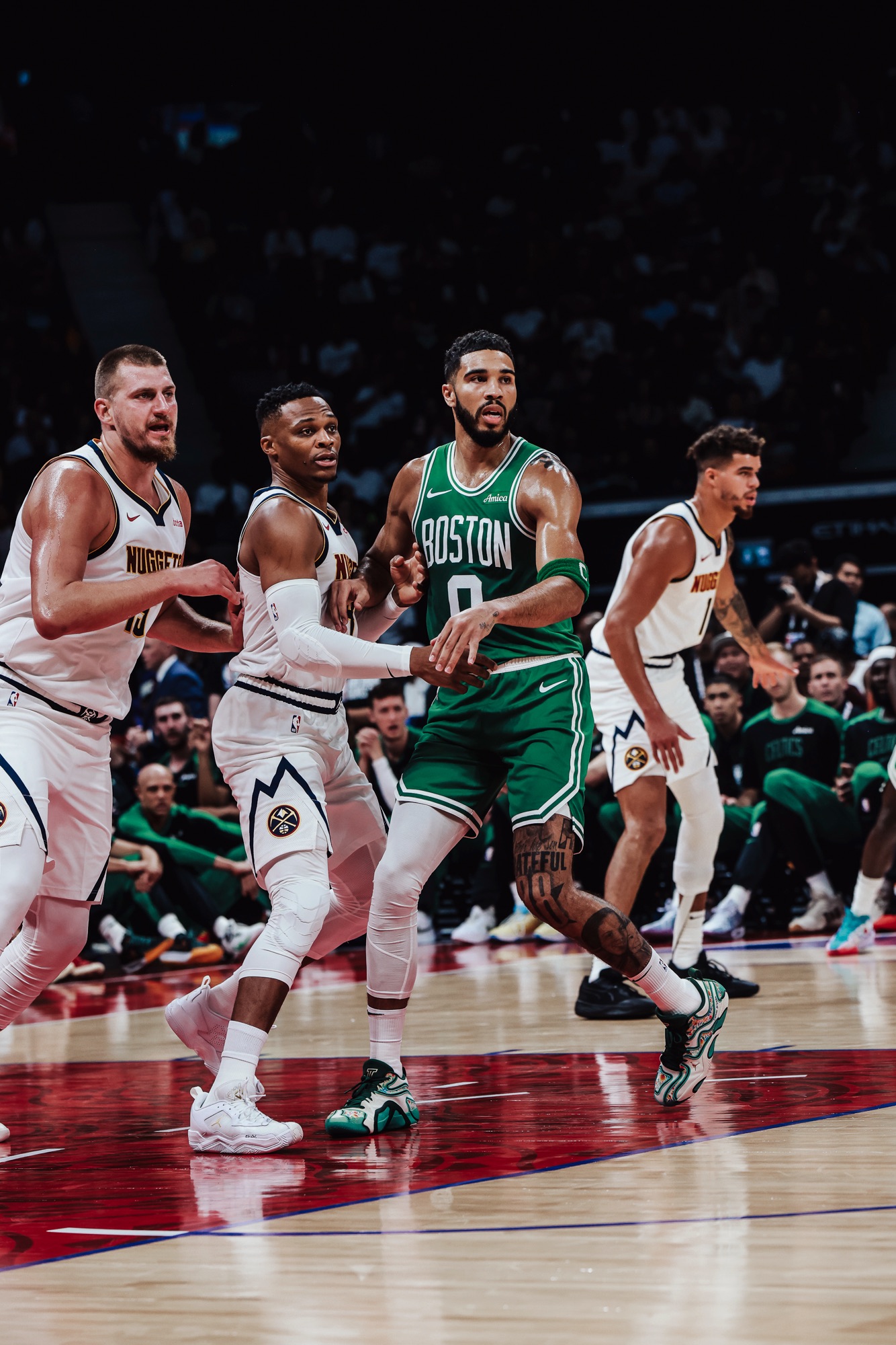 Boston No. 0 in green battling for position against Denver players in white