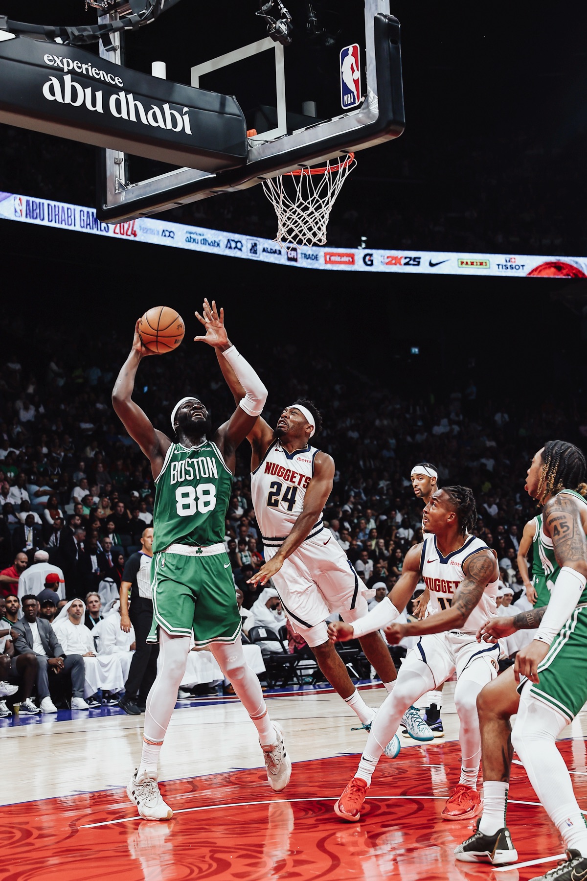 Boston No. 88 going up for a shot against Denver defenders under the basket