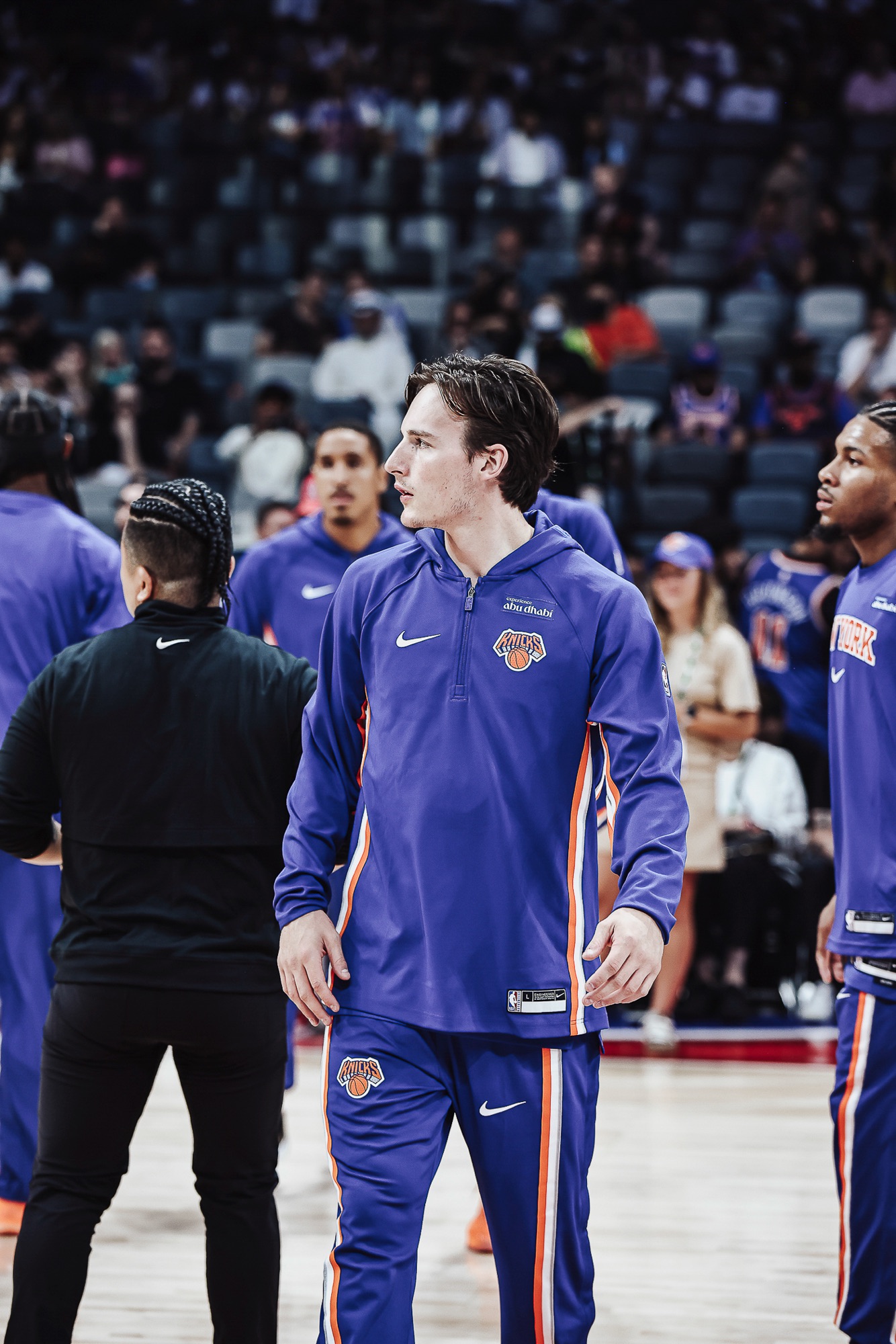 New York player in a blue warm-up hoodie on court before the game