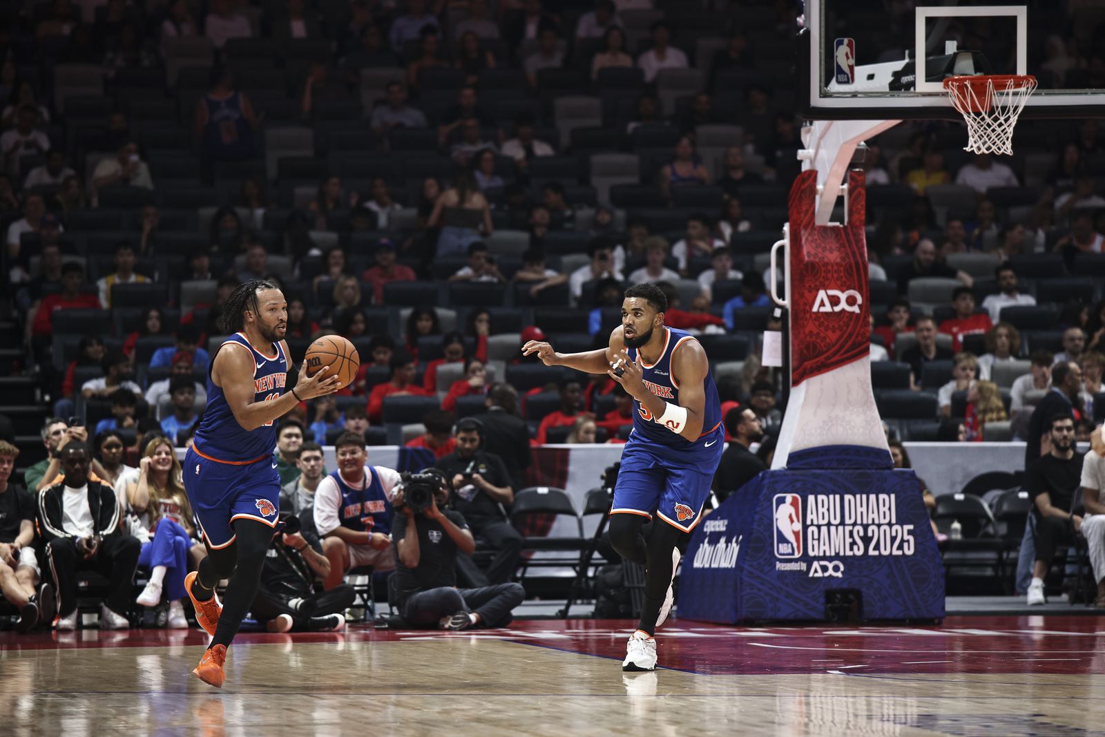 Wide view of a basketball game in a packed arena